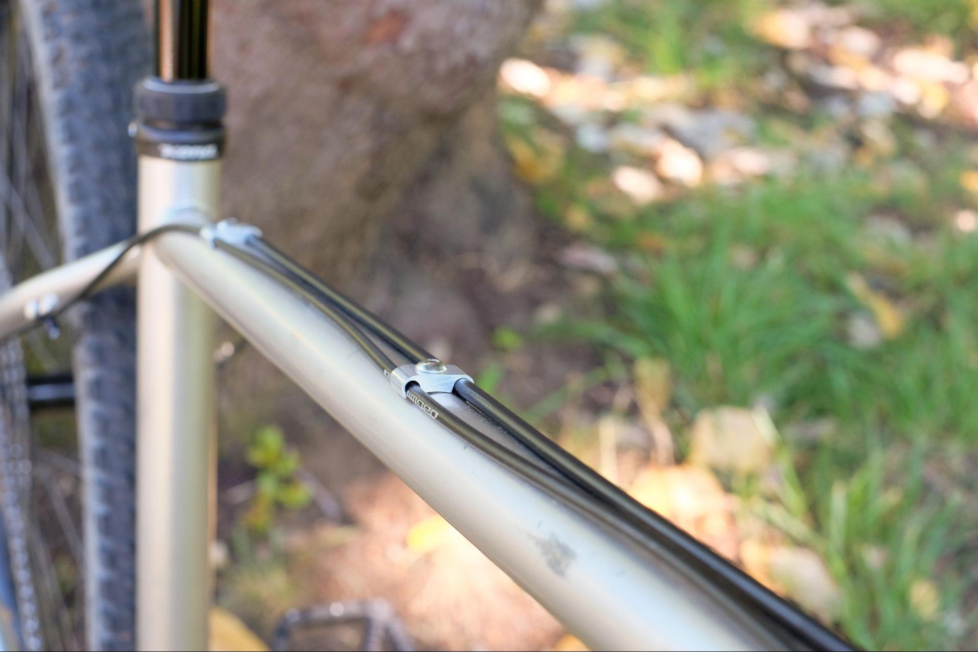Slick bolt-on cable management along the top tube